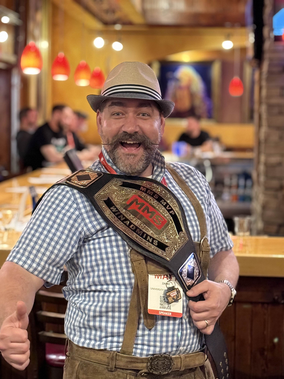 Matt poses in lederhosen while carrying the MMS MVP WinAdmins championship belt.